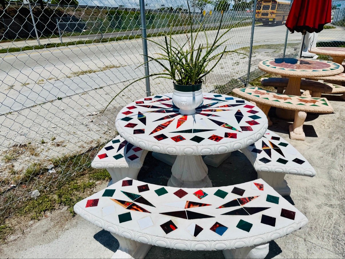 White table with multicolor mosaic tiles and benches