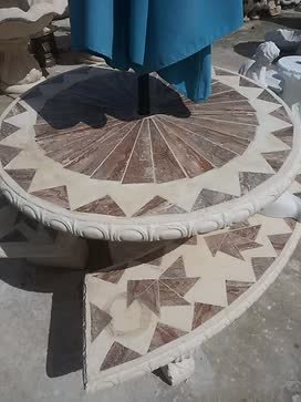 Beige table with brown sunburst tiles and benches